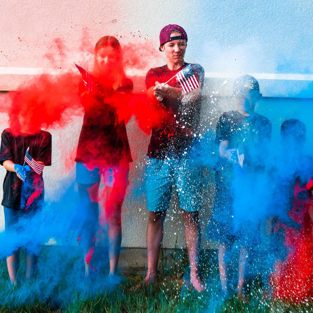 Kids with American flags in red, white, and blue smoke clouds.